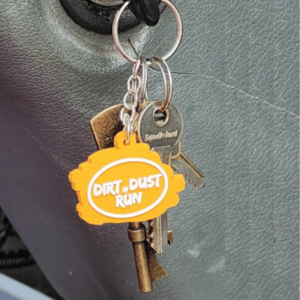 a picture of the keyring on a set of keys, hanging from an ignition of a car